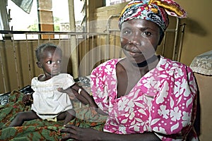 Portrait proud mother with child in Ghanaian hospital