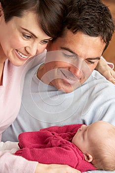 Portrait Of Proud Parents With Newborn Baby