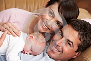 Portrait Of Proud Parents With Newborn Baby photo
