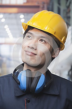 Portrait of Proud Young Engineer Wearing a Yellow Hardhat