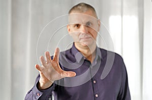 Portrait of a psychosomatic psychologist making a hand gesture to attract attention photo