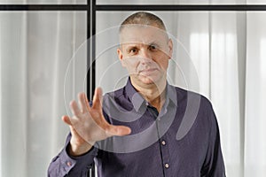 Portrait of a psychosomatic psychologist making a hand gesture to attract attention photo