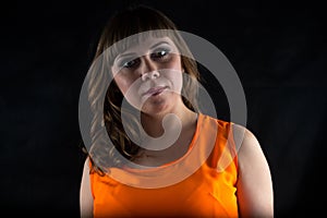 Portrait of pudgy woman in orange dress