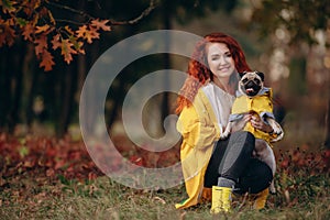 Portrait of a pug and its owner.