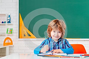 Portrait of Pupil of primary school study indoors. Pupil learning letters and numbers. Cute little preschool kid boy