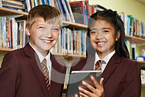 Portrait Of Pupils Wearing School Uniform Using Digital Tablet I photo