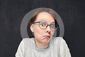 Portrait of puzzled girl looking with bewilderment at camera