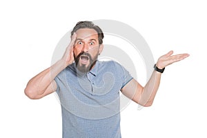 Portrait of puzzled man touching his head and keeping his mouth open