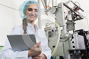 Portrait of quality control inspector smiling during inspection