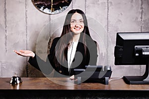 Portrait of receptionist at desk in lobby. Banner design. Friendly concierge at hotel reception behind the counter