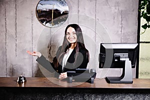 Portrait of receptionist at desk in lobby. Banner design. Friendly concierge at hotel reception behind the counter