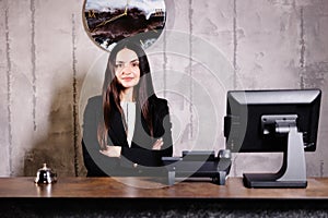 Portrait of receptionist at desk in lobby. Banner design. Friendly concierge at hotel reception behind the counter