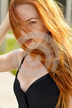 Portrait of a red-haired girl with green eyes