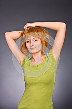 Portrait of the red-haired girl in a green T-shirt