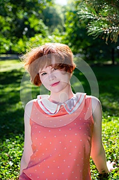 Portrait of a red-haired happy girl in park