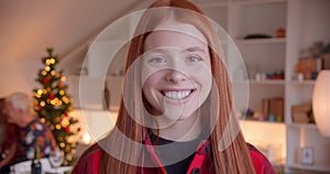 Portrait of red-haired happy teenage girl Christmas New Year smiling laughing