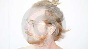 Portrait of red-haired man with beard and manbun