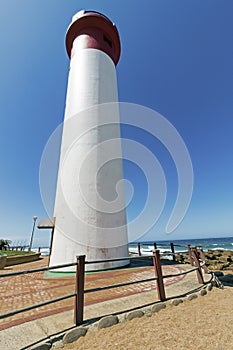 Portrait Red and White Lighthouse on Coastal Landscape