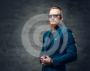 Redhead bearded hipster male dressed in a blue jacket.