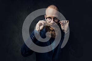 Redhead bearded male in a suit.