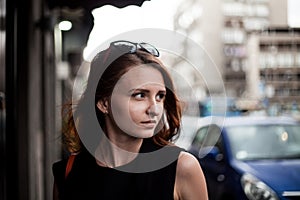 Portrait of a redhead business woman looking for something in a street od Belgrade, Serbia