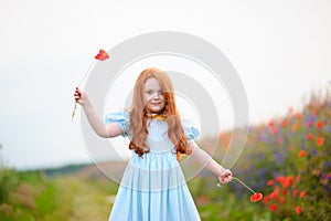 portrait of a redhead little girl outdoors. beautiful stylish romantic young girl