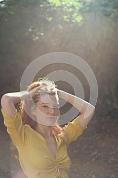 Portrait Of Redhead Young Woman Holding Hair