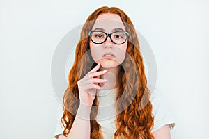 Portrait of redheaded woman in eyeglasses on  white backgroung, learning and teaching concept
