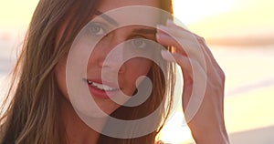 Portrait of a relax and happy woman face at the beach during a summer sunset. Beautiful female with happiness, calm and