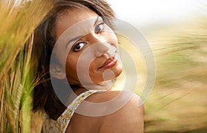 Portrait, relax or happy woman in a field, countryside or outdoor garden in spring for freedom on break. Smile, wellness