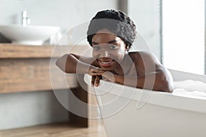 Portrait of relaxed african american young woman taking bath