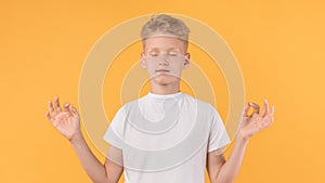 Portrait of relaxed boy meditating with closed eyes