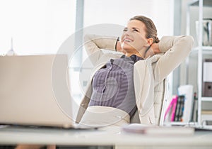 Portrait of relaxed business woman in office photo