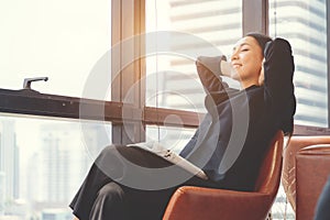 Portrait of relaxed business woman in office. Relax and freedom concept