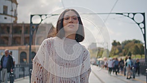 Portrait relaxed girl looking camera confidently walking tram rails in sunlight