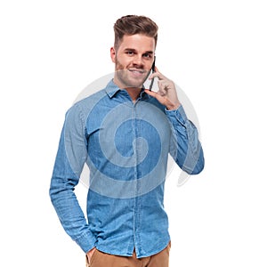 Portrait of relaxed young casual man talking on the phone