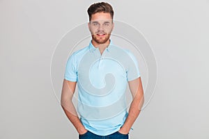 Portrait of relaxed young man wearing light blue polo t-shirt