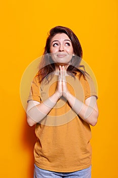 Portrait of religious woman doing gesture with hands to pray