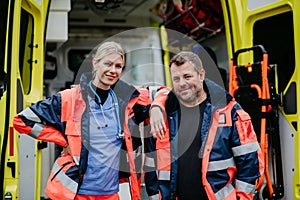 Portrait of rescuers in front of ambulance car.