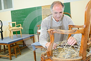 Portrait retired man standing at workshop and working