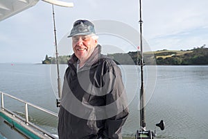 Portrait of a retired senior male tourist on a fishing charter b