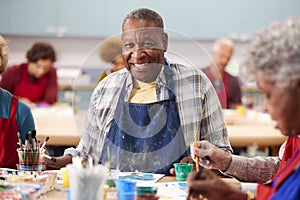 Portrait Of Retired Senior Man Attending Art Class In Community Centre