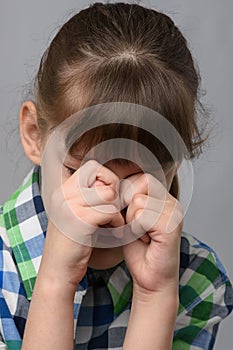 Portrait of a roaring ten-year-old girl of European appearance, close-up