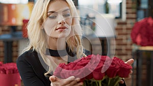 Portrait of romantic beautiful woman smiling and smelling roses feeling in love admiring luxury gift bouquet of roses