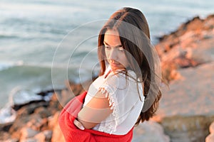 Portrait of romantic beautiful woman in white dress at the sea beach