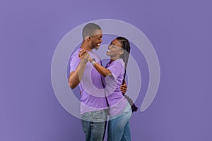 Portrait of romantic black couple dancing at studio