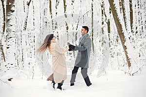 Portrait of a romantic couple spending time together in winter forest