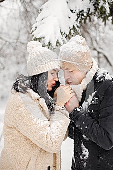 Portrait of romantic couple walking in forest at winter day