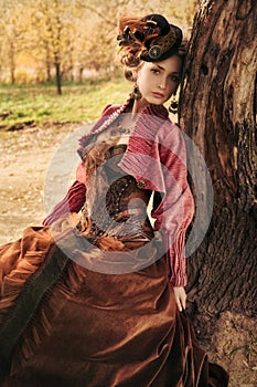 Portrait of romantic girl in historical dress.