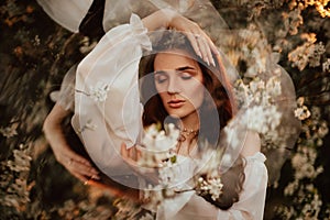 Portrait of a romantic girl, like a forest fairy, in a blooming garden with elements of phantasmagoria. The concept of